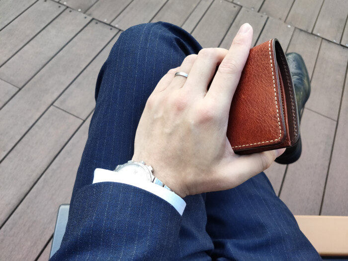 review-tsuchiya-kaban-urbano-compact-coin-purse-hand-hold-at-bench